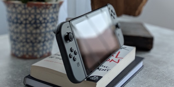 Photo by Dennis Eichler on Unsplash (Nintendo Switch on Books)